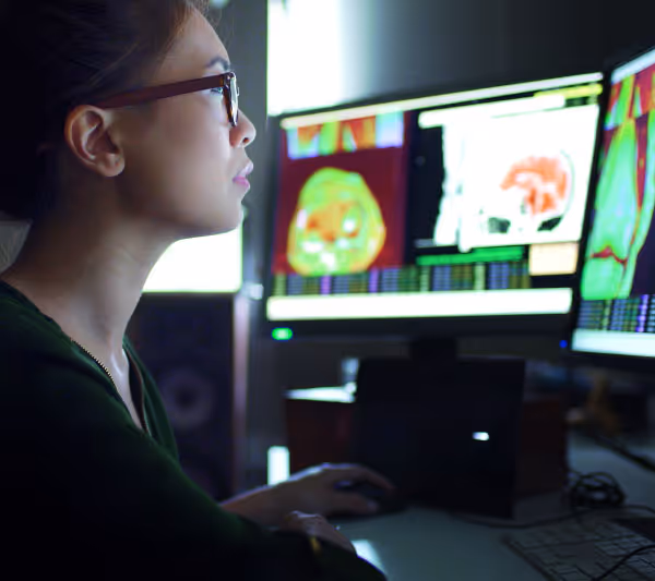 Healthcare worker studying a computer screen