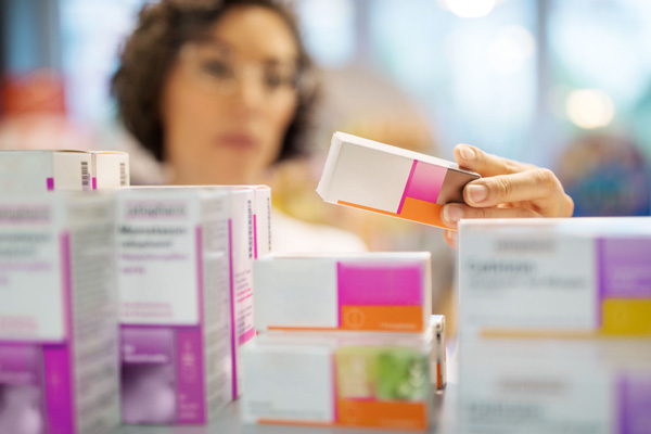 woman putting away medicine